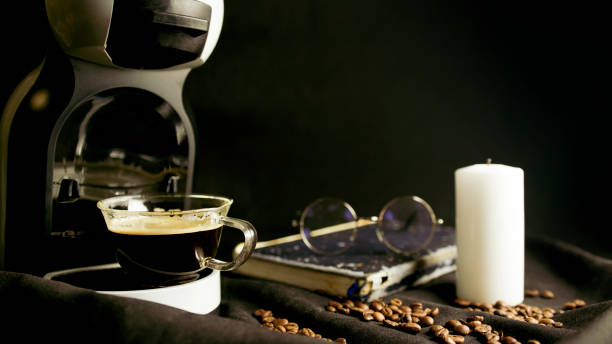 istock Coffee Americano pouring from coffee machine. Home professional coffee machine with coffee cup 1369620904
