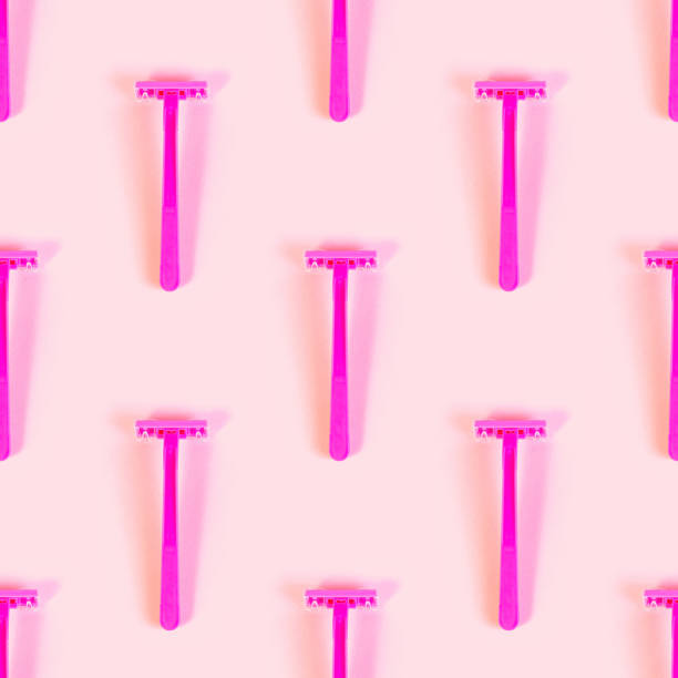 istock Pink disposable woman razor repeat seamless pattern on light pastel background. Hair removing, epilation procedure and shaving wrapping paper design 1369622796