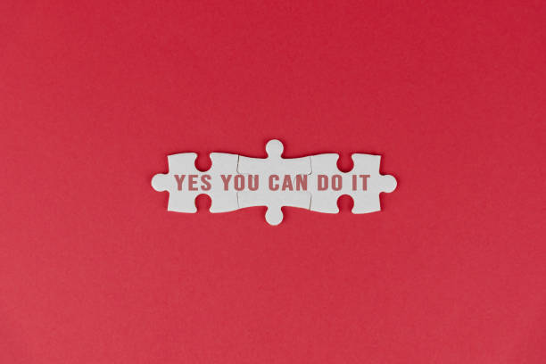 istock Yes you can do it. Text motivation on white puzzle jigsaw on red background. 1369622930