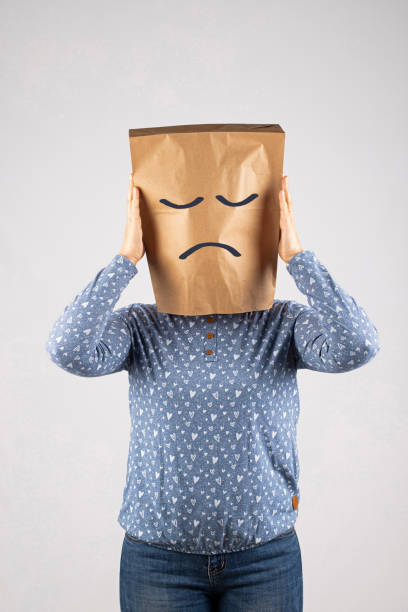 Woman with paper bag on head