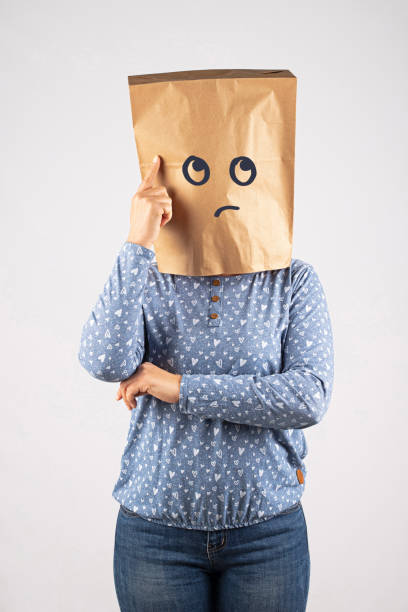Woman with paper bag on head