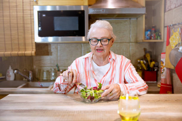 istock Old lady having healthy meal. 1369624381