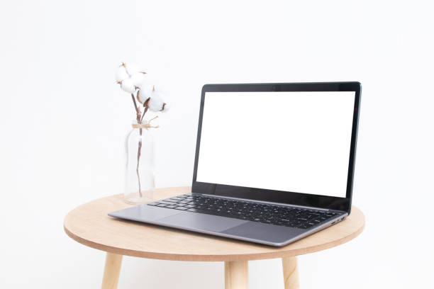 istock Blank modern laptop screen mockup in minimalistic interior design for displaying your website or advertising internet services 1369625944