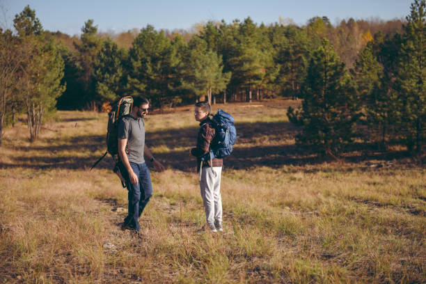 istock Young backpackers going hiking and walking through a sandstone valley 1369632004