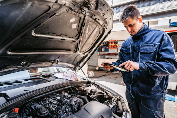 istock Mechanic examining car diagnostics on digital tablet 1369634246