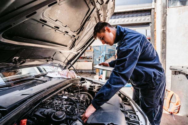 istock Mechanic examining car diagnostics on digital tablet 1369634377