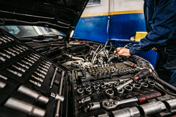 istock Auto mechanic fixing a car in a workshop 1369634610