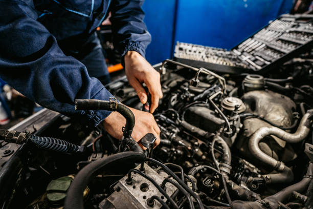 istock Auto mechanic fixing a car in a workshop 1369635463