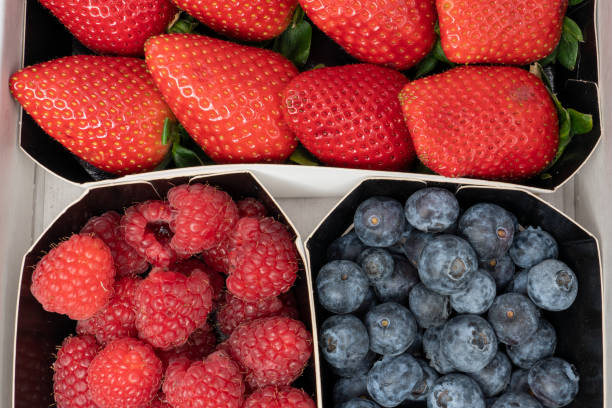istock trays with berries, fresh strawberries, ripe blueberries and raspberries 1369635539