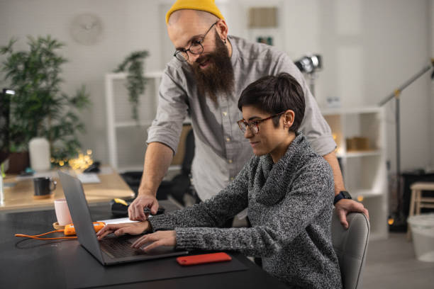 istock Couple working in modern office 1369636133