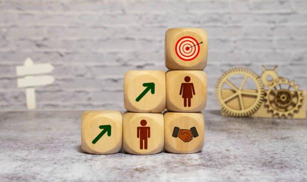 istock Hand putting virtual target board and arrow which print screen on wooden cube. 1369638313