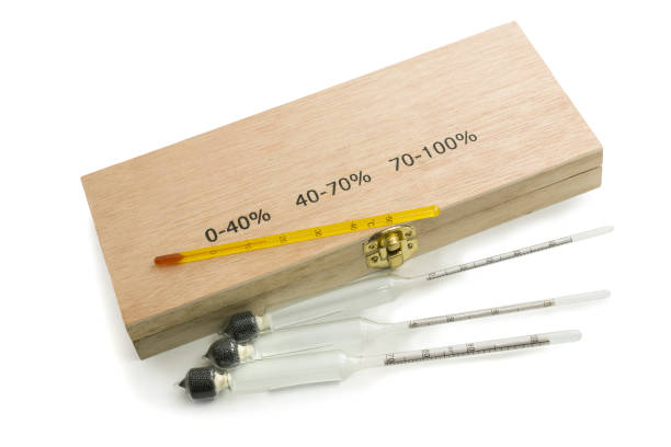 istock Three hydrometers for measuring degree of alcohol and thermometer in white background 1369638571