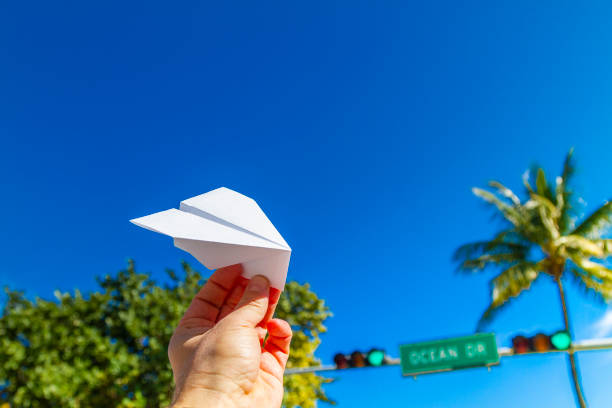 POV Point of view shot of a young travel male enjoying his vacations while playing with a paper airplane in front of Ocean Drive, South Beach, Miami Beach, Miami, South Florida, United States of America. Travel Concept. POV Point of view shot of a young travel male enjoying his vacations while playing with a paper airplane in front of Ocean Drive, South Beach, Miami Beach, Miami, South Florida, United States of America
The picture is in the famous and touristic Art Deco District. Shooting from a personal perspective in an exotic tropical beach travel holidays.
Travel Concept. 1 hotel south beach stock pictures, royalty-free photos & images