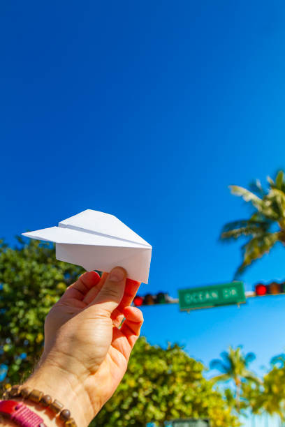 POV Point of view shot of a young travel male enjoying his vacations while playing with a paper airplane in front of Ocean Drive, South Beach, Miami Beach, Miami, South Florida, United States of America. Travel Concept. POV Point of view shot of a young travel male enjoying his vacations while playing with a paper airplane in front of Ocean Drive, South Beach, Miami Beach, Miami, South Florida, United States of America
The picture is in the famous and touristic Art Deco District. Shooting from a personal perspective in an exotic tropical beach travel holidays.
Travel Concept. 1 hotel south beach stock pictures, royalty-free photos & images