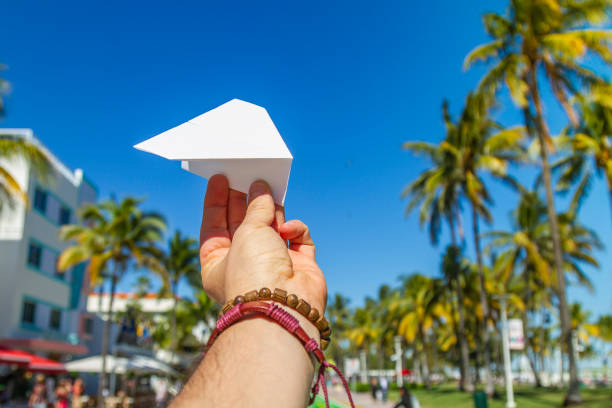 POV Point of view shot of a young travel male enjoying his vacations while playing with a paper airplane in front of Ocean Drive, South Beach, Miami Beach, Miami, South Florida, United States of America. Travel Concept. POV Point of view shot of a young travel male enjoying his vacations while playing with a paper airplane in front of Ocean Drive, South Beach, Miami Beach, Miami, South Florida, United States of America
The picture is in the famous and touristic Art Deco District. Shooting from a personal perspective in an exotic tropical beach travel holidays.
Travel Concept. 1 hotel south beach stock pictures, royalty-free photos & images