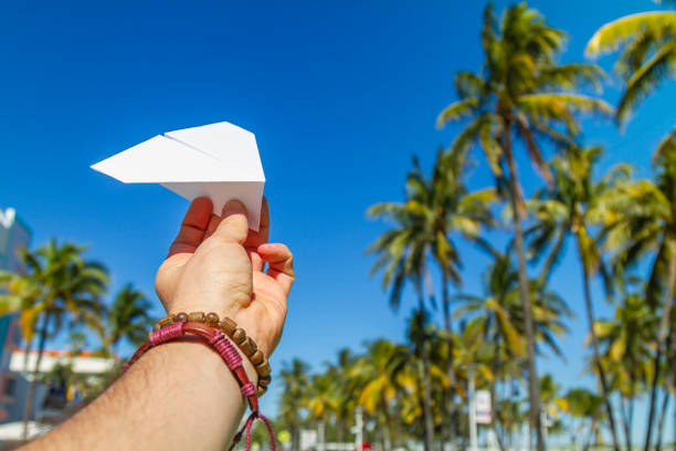 POV Point of view shot of a young travel male enjoying his vacations while playing with a paper airplane in front of Ocean Drive, South Beach, Miami Beach, Miami, South Florida, United States of America. Travel Concept. POV Point of view shot of a young travel male enjoying his vacations while playing with a paper airplane in front of Ocean Drive, South Beach, Miami Beach, Miami, South Florida, United States of America
The picture is in the famous and touristic Art Deco District. Shooting from a personal perspective in an exotic tropical beach travel holidays.
Travel Concept. 1 hotel south beach stock pictures, royalty-free photos & images