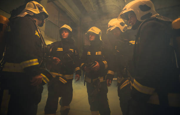istock Group of firefighters with uniform inside the  fire station preparing for safe rescue 1369642209