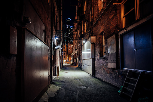 Dark and eerie urban city alley at night