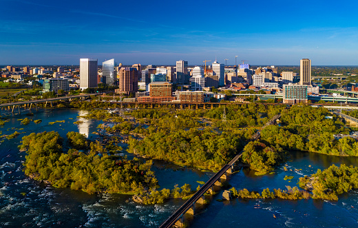 Downtown Richmond skyline aerial view with James River and some of its islands and rapids in the foreground.
