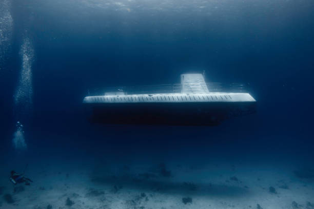 istock diver amazed because he found a submarine in the sea 1369643354