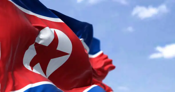 Detail of the national flag of North Korea waving in the wind on a clear day. Patriotism. Selective focus. East asia country.