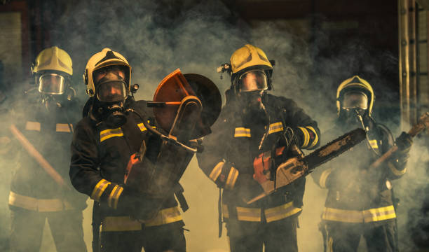 istock Group of firefighters in uniform posing inside the fire department's garage 1369643994
