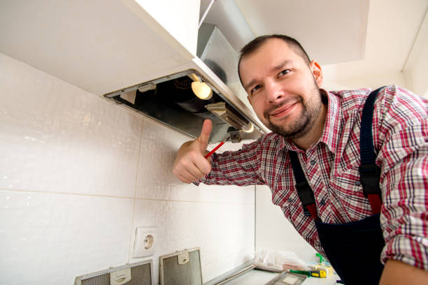 istock Repairman work on ventilation in the kitchen 1369645392