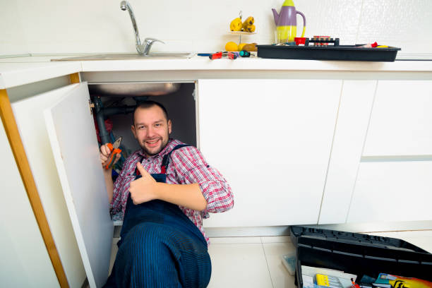 istock Handyman Lying On Floor Repairing Sink In Kitchen 1369645402
