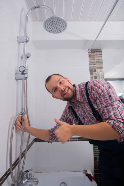 istock handyman repairing shower head in bathroom 1369645526