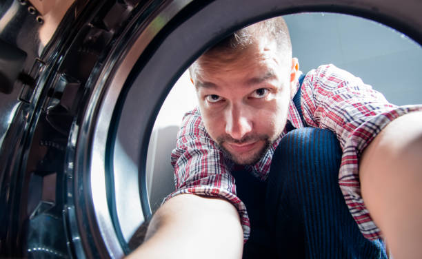 istock Plumber repairing washing machine 1369645535