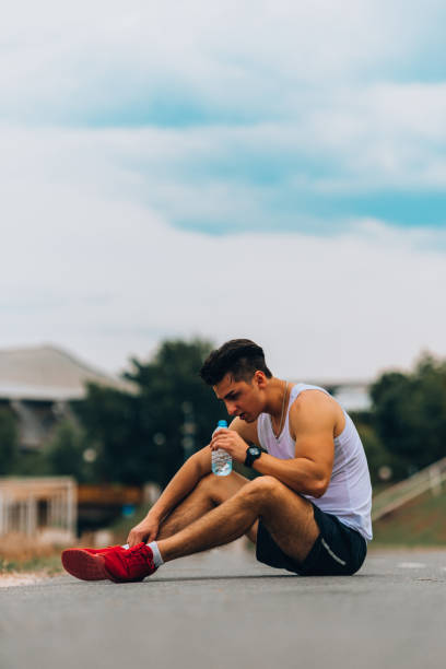 istock Tired athlete refreshing him self with fresh water 1369646561
