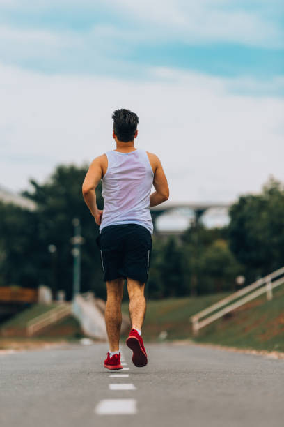 istock Male runner at sprinting speed training for marathon outdoors 1369646567