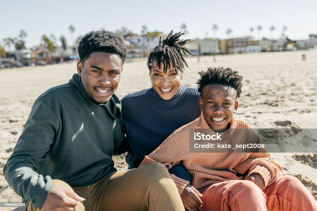 Best Family Vacations That Will Please Travelers Young and Old Alike Family on the beach Family Stock Photo