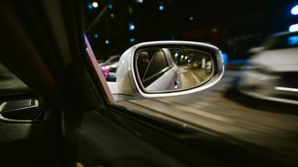 istock The rear mirror of a fast-moving car at night 1369652496
