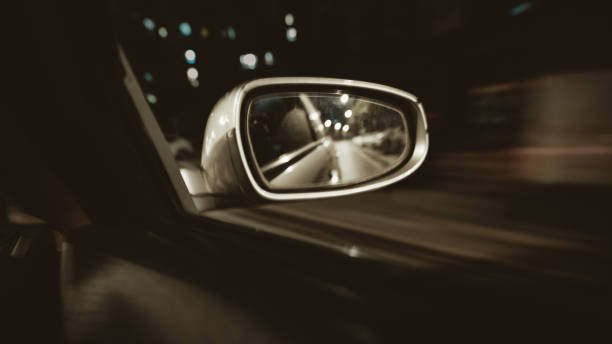 istock The rear mirror of a fast-moving car at night 1369652541