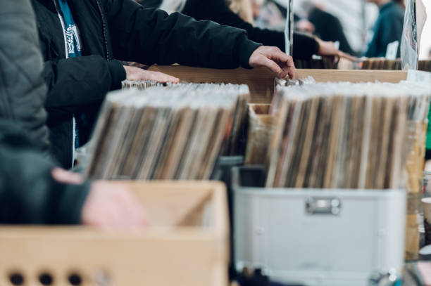 istock Man hands browsing vinyl album in a record store 1369652693