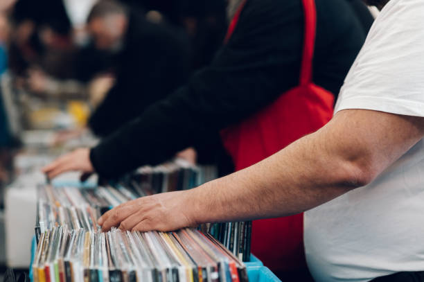 istock Man hands browsing vinyl album in a record store 1369652694