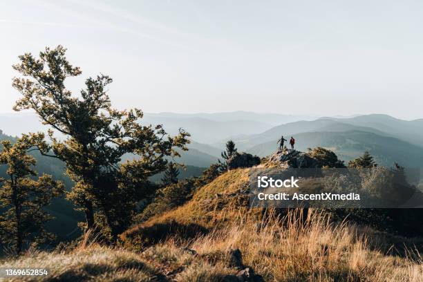 Young Couple Backpack Up A Mountain Summit Stock Photo - Download Image Now - Black Forest - Germany, Hiking, Wellbeing