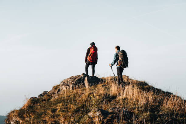 istock Young couple with backpacks relax on a mountain summit 1369652929
