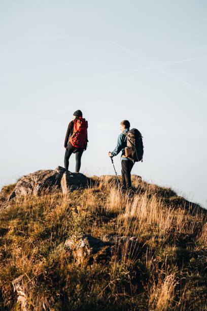 istock Young couple with backpacks relax on a mountain summit 1369653008
