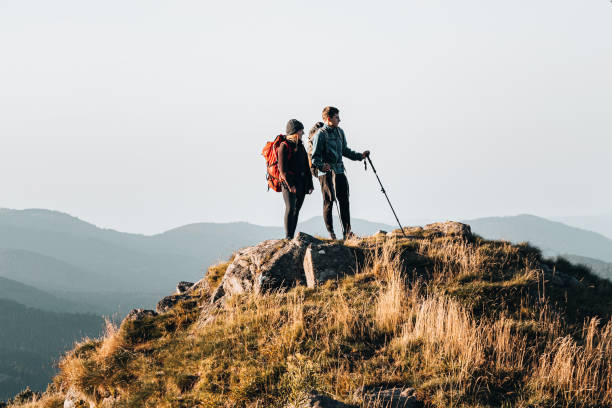 istock Young couple with backpacks relax on a mountain summit 1369653661