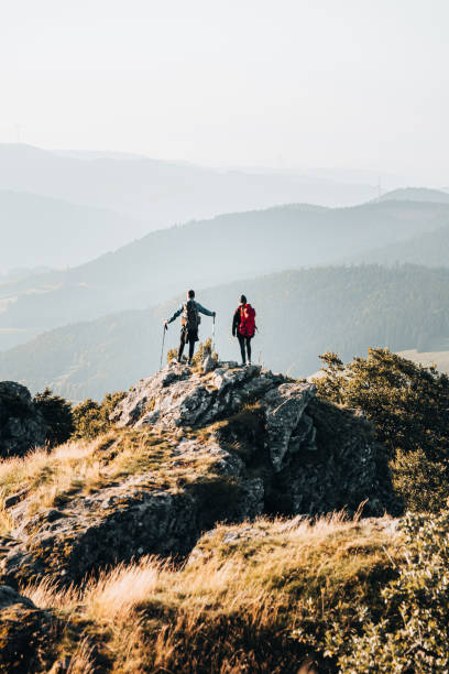 istock Young couple with backpacks relax on a mountain summit 1369653734