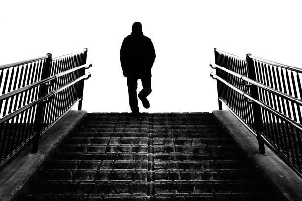 istock Silhouette of a man climbing stairs 1369660804