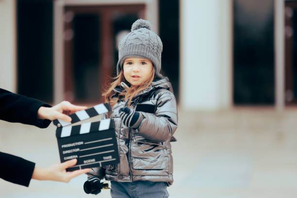 Child Acting Natural Looking at the Camera Filming a Commercial Little kid taking acting classes displaying natural talent and skill in front of the camera audition photos stock pictures, royalty-free photos & images