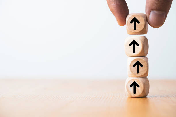 istock Hand putting up or increasing arrow which print screen on wooden cube block for dividend benefit growth and enhance investment concept. 1369661993