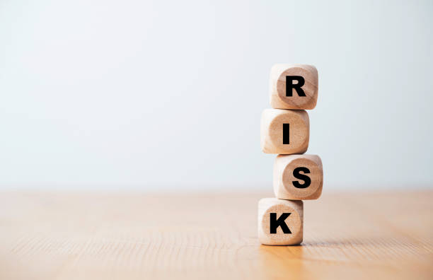istock Risk wording print screen on unstable wooden cube block for risk management concept. 1369662683