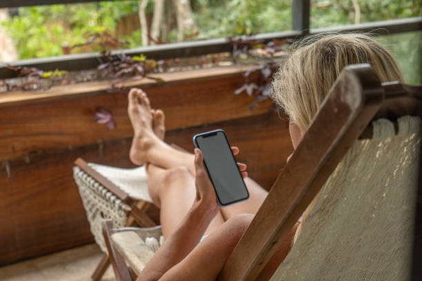 istock Woman using smartphone at home 1369662916