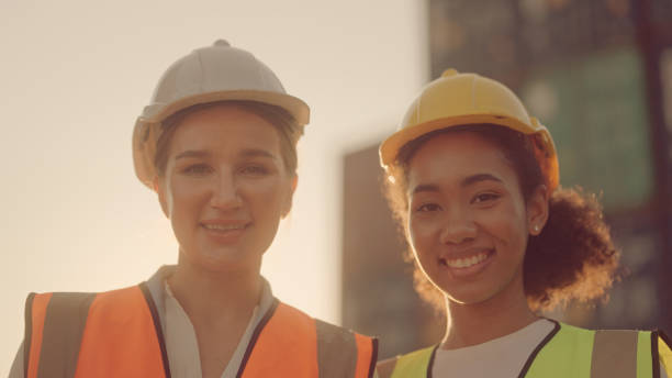 istock Two female shipping working and checking container in the port 1369665641