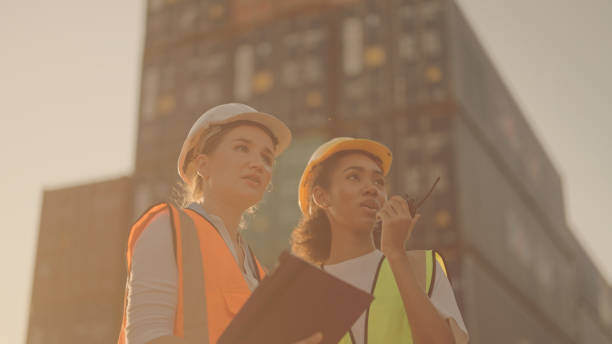 istock Two female shipping working and checking container in the port 1369665706