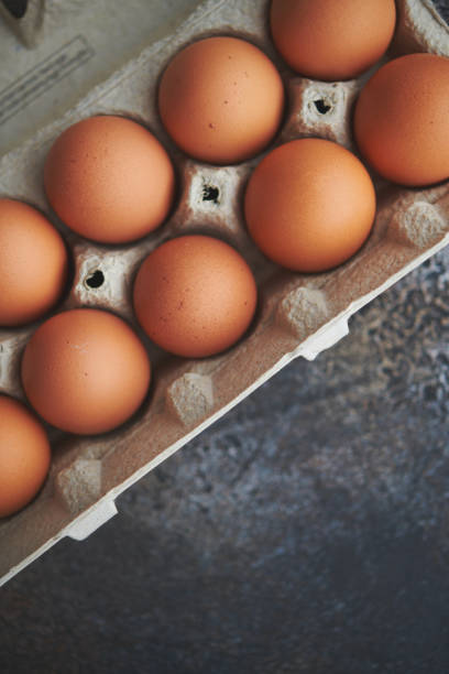 istock Fresh organic brown eggs in a cardboard egg carton with space for text 1369668545